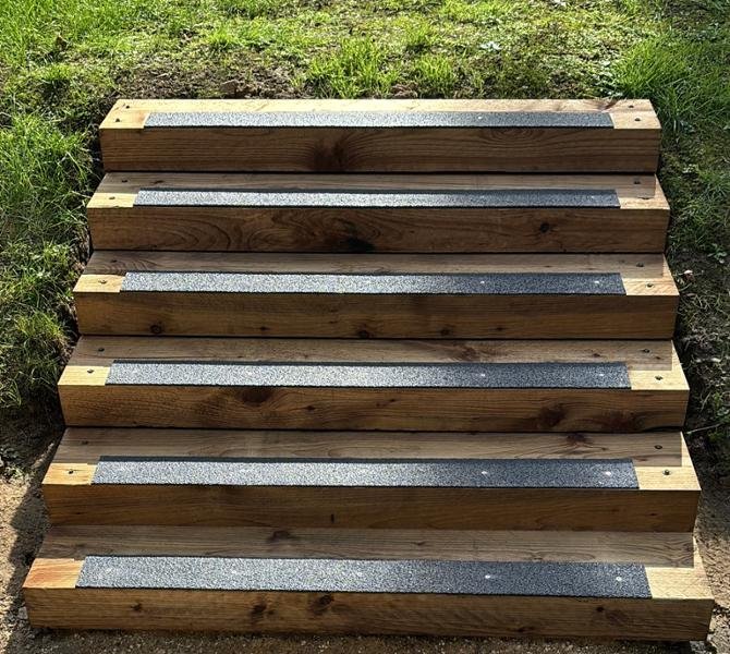 Black GRP anti-slip cleats on wooden steps