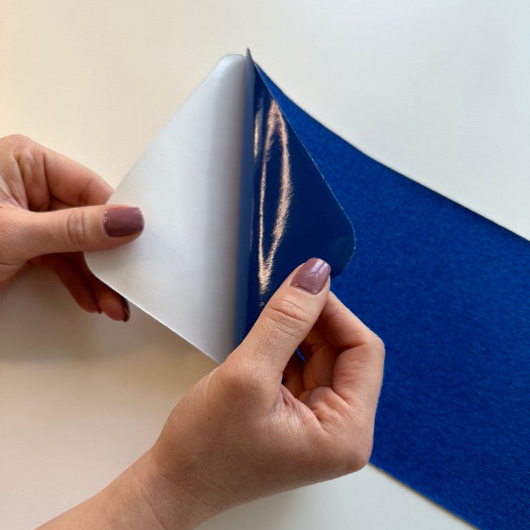 Person peeling aback blue anti slip tape 