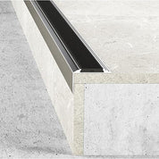 Close-up of a concrete floor with a aluminium rubber stair nosing