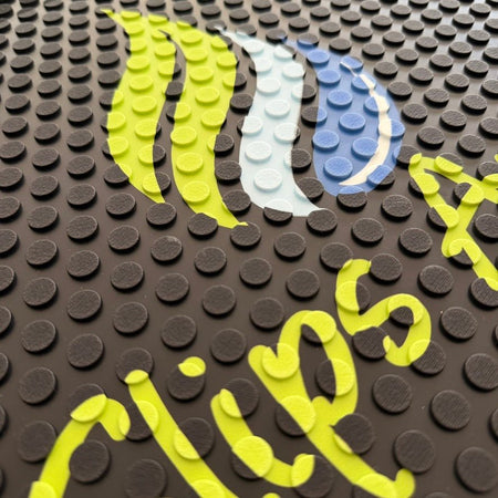 Close-up of a Personalised Custom logo mat  from i on a rubber bobble textured surface.