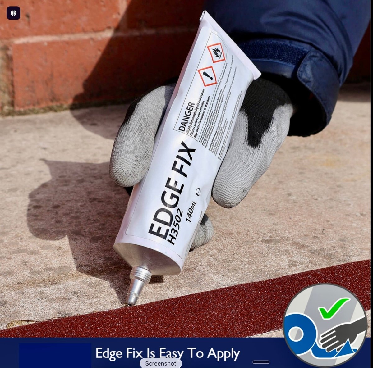 Hand holding a tube of 'Edge Fix' sealant against a brick wall background