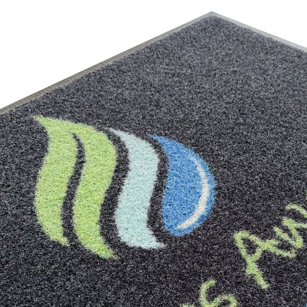 Close-up of a Slips Away promo scrape custom logo entrance mat 