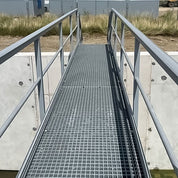 GRP staircase leading up to a building with a cloudy sky in the background