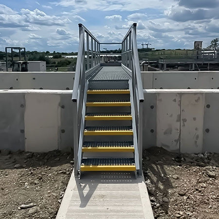 GRP Staircase with yellow steps and metal railing on a construction site