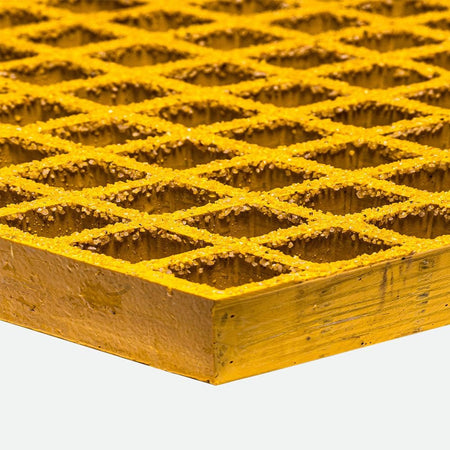 Close-up of a yellow grating with a diamond pattern on a white background