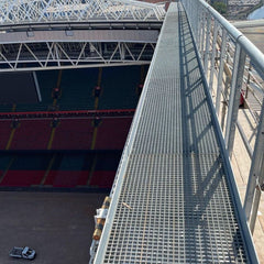 Stadium with a GRP MESH PANELS walkway leading to the stands