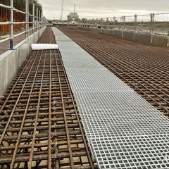 Construction site with grp mesh panels and grid pattern on a concrete floor.