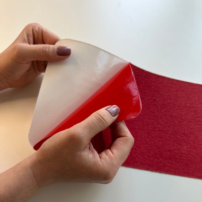 Person peeling a red anti slip tape