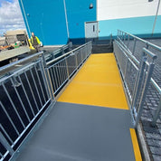 Yellow and gray ramp leading to a blue building